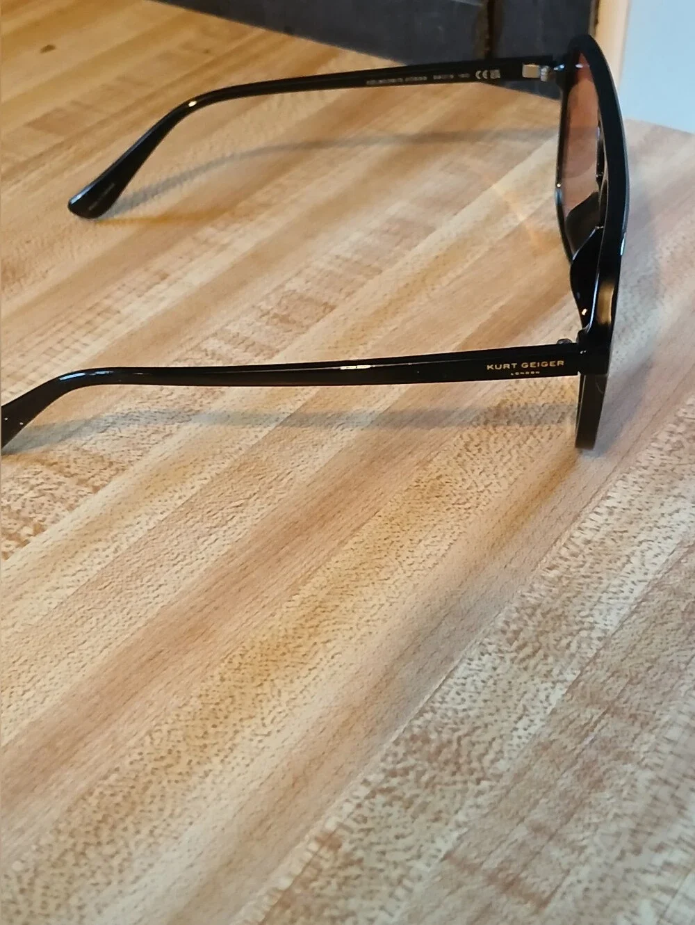 Kurt Geiger Black Frame Sunglasses with Pink Lenses